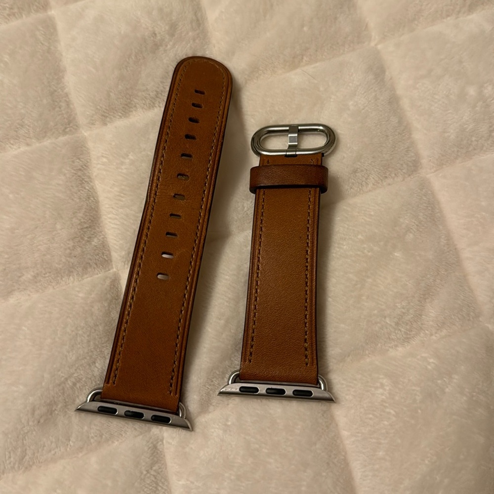 Brown leather Apple Watch band.